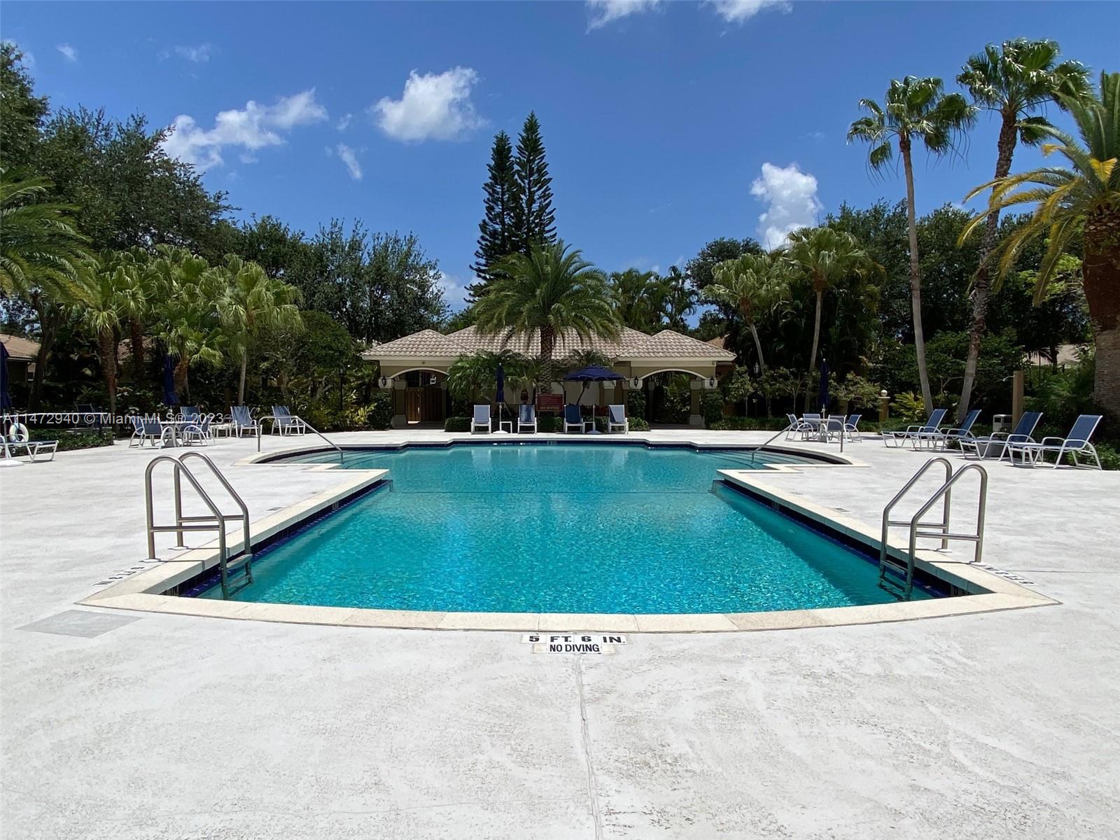 6636 Northwest 25th Avenue Boca Raton, FL 33496 - Photo 66 of 96 a view of swimming pool with outdoor seating and trees in the background