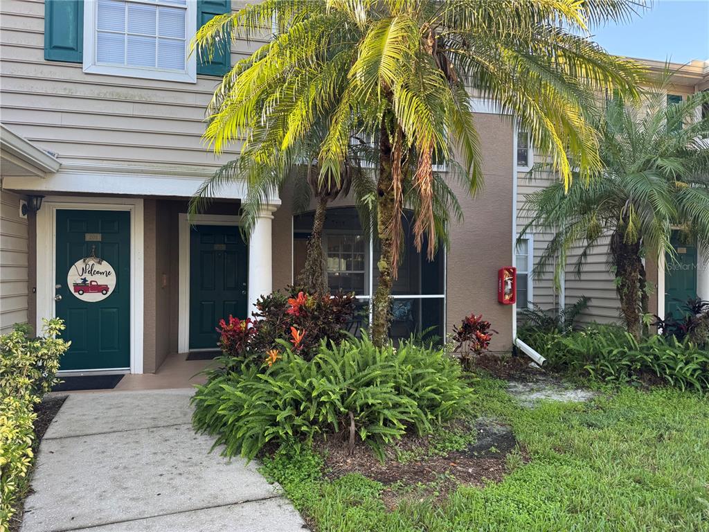 8911 Manor Loop, Unit 101 Lakewood Ranch, FL 34202 - Photo 1 of 1 a view of the house with potted plants