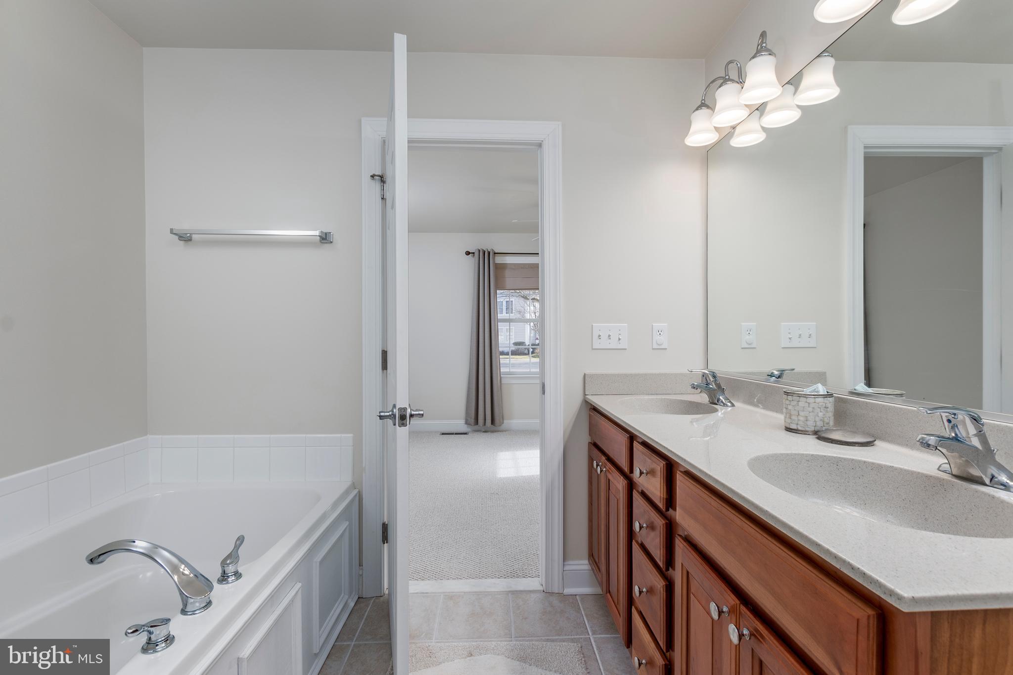 33878 Waterside Drive, Unit 15 Frankford, DE 19945 - Photo 17 of 38 Master bath with double vanity and tub