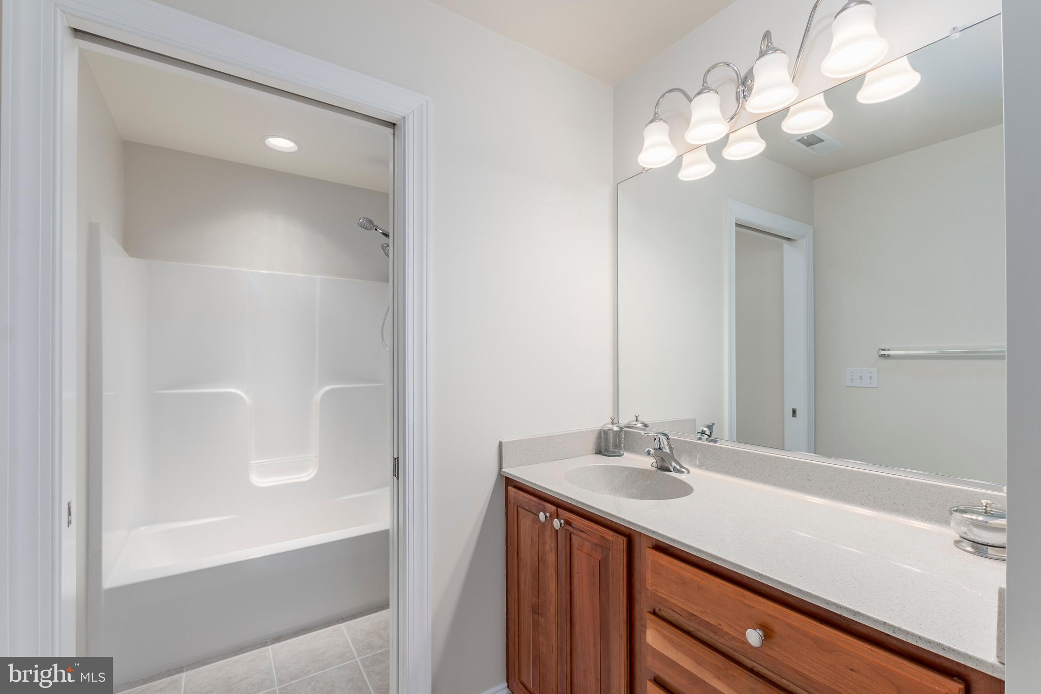 33878 Waterside Drive, Unit 15 Frankford, DE 19945 - Photo 25 of 38 Hall bath with pocket door to separate tub/shower