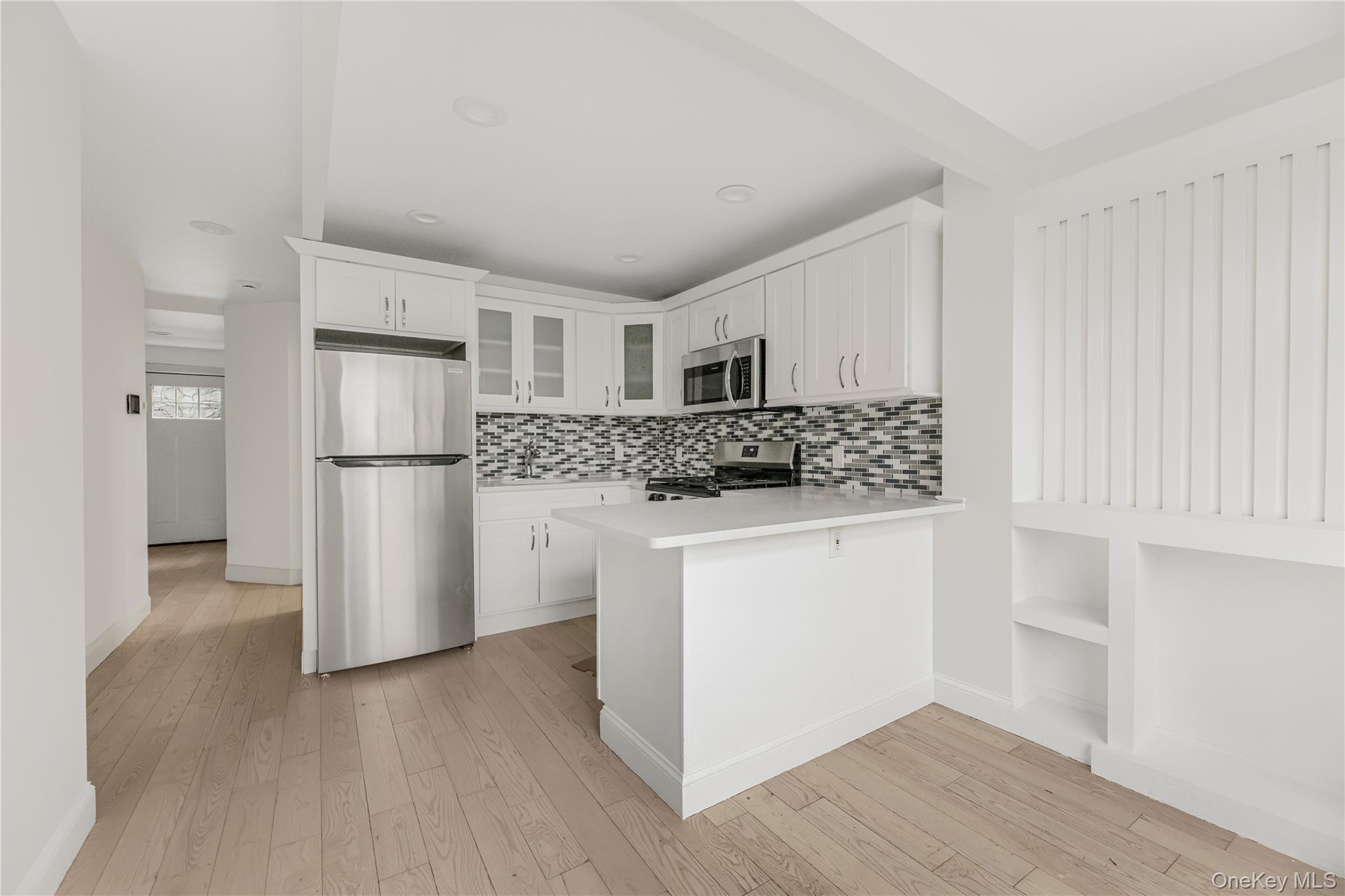 3067 Williamsbridge Road Bronx, NY 10467 - Photo 15 of 29 a kitchen with stainless steel appliances a refrigerator sink and cabinets