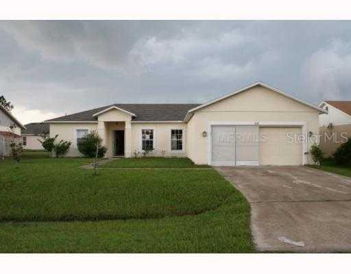 909 Gillingham Court Kissimmee, FL 34758 - Photo 1 of 1 a front view of a house with a yard and garage