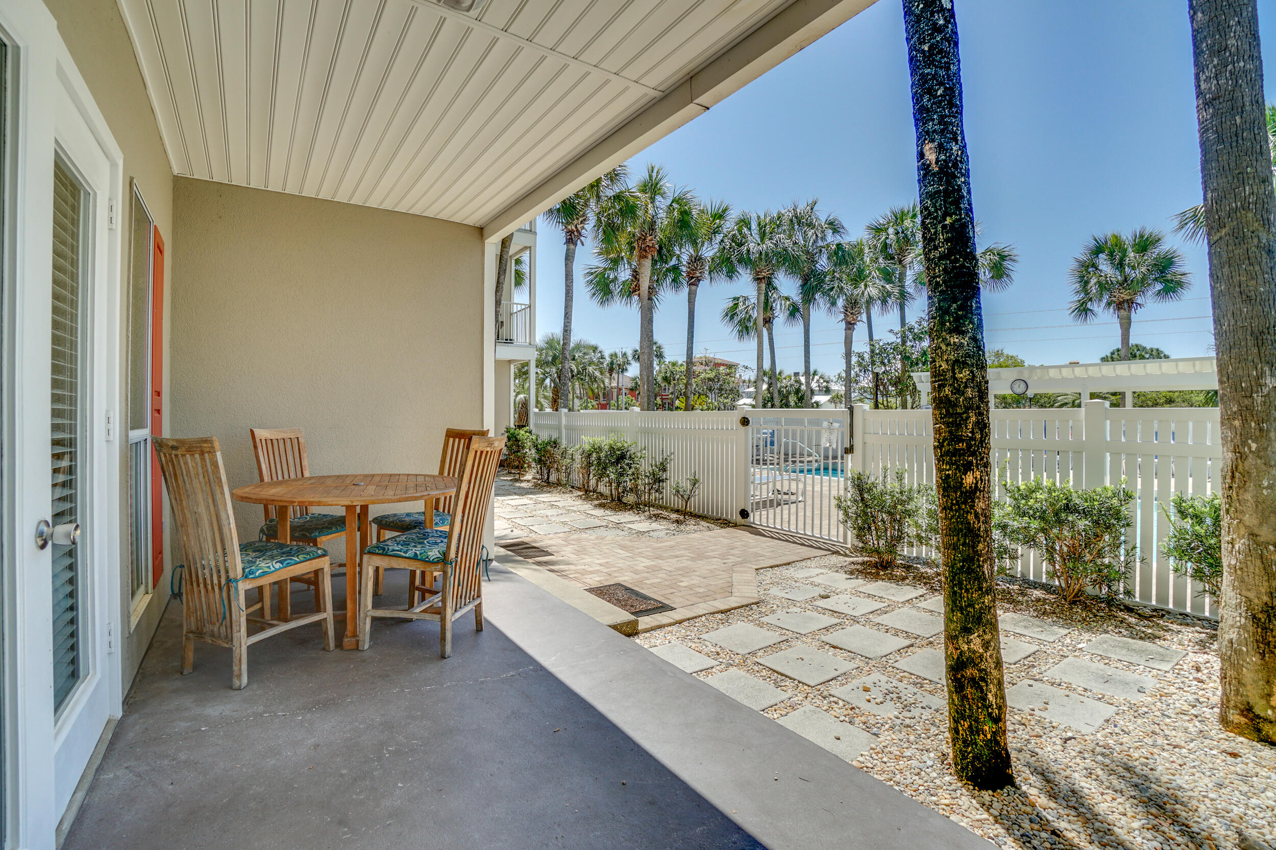144 Spires Lane, Unit 107 Santa Rosa Beach, FL 32459 - Photo 16 of 17 a view of a patio with a table and chairs and potted plants