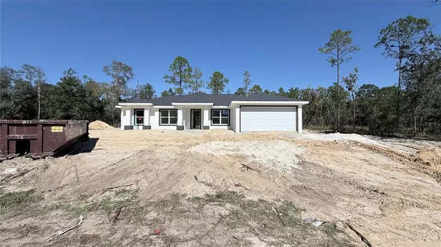 a view of a house with a snow in the background