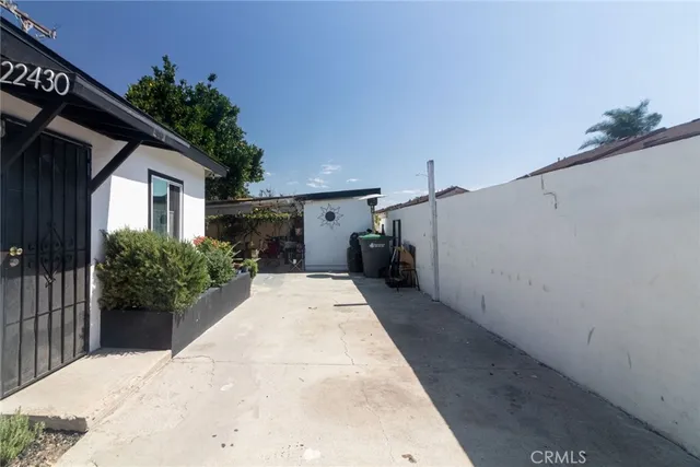 a house with potted plants in front of it