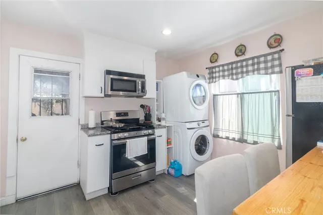 a kitchen with stainless steel appliances granite countertop a stove and a refrigerator