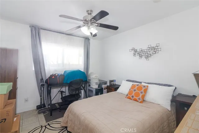 a bedroom with bed and a chair