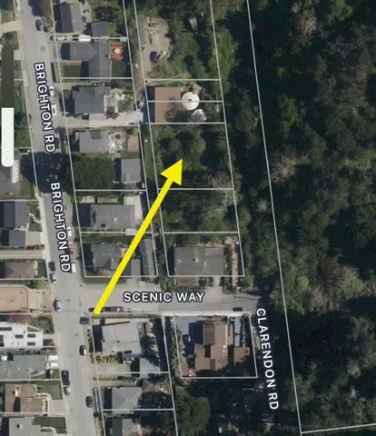 an aerial view of residential house with outdoor space and trees all around