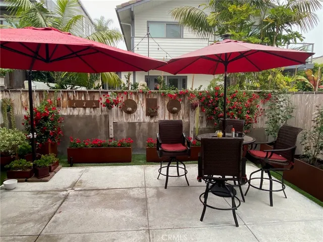a view of a patio with chairs and a umbrella
