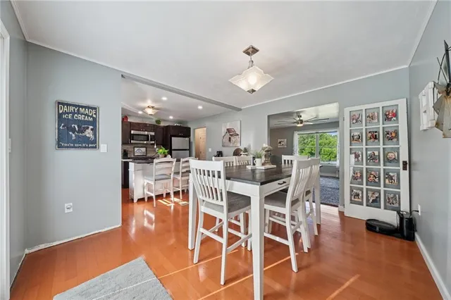 a dining room with furniture and wooden floor