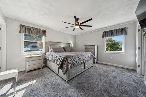 a bedroom with a large bed and a window
