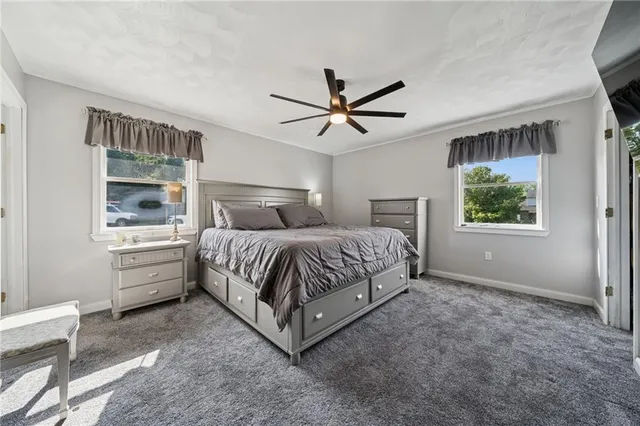 a bedroom with a large bed and a window