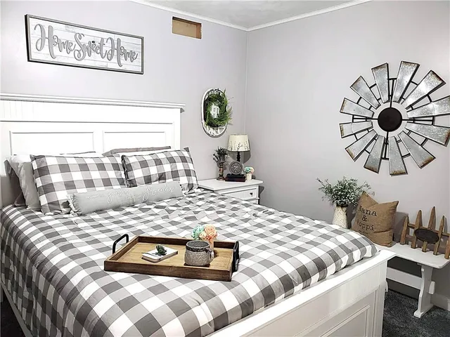 a bedroom with a bed and painting on the wall