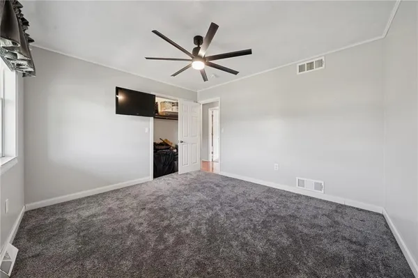 a view of a livingroom with a ceiling fan and window