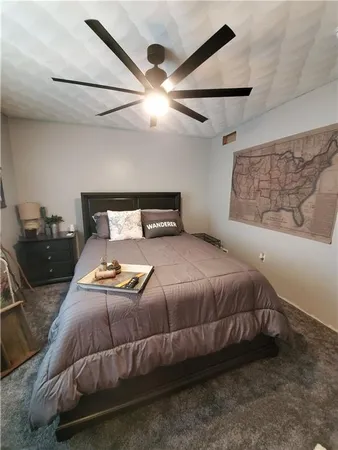 a bedroom with a bed and ceiling fan