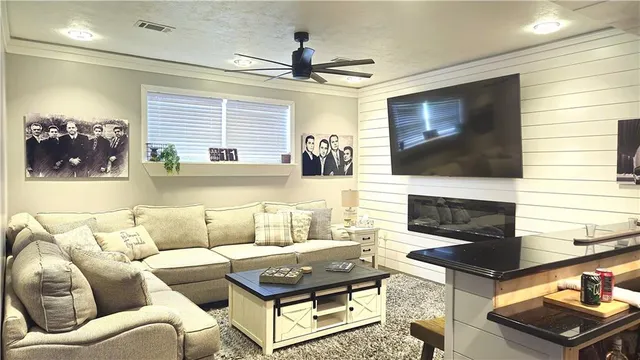a living room with furniture and a flat screen tv