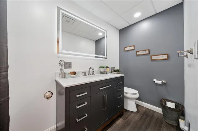 a bathroom with a toilet a sink and mirror