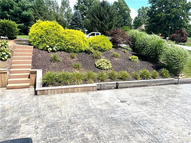 a view of a garden with an outdoor seating