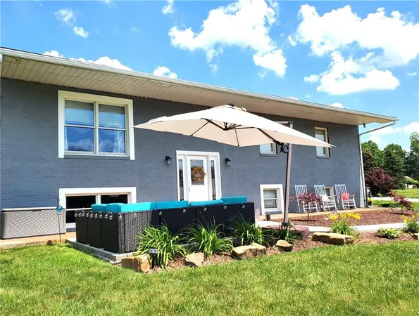 a backyard of a house with table and chairs