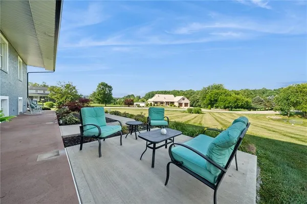 a swimming pool with outdoor seating and deck