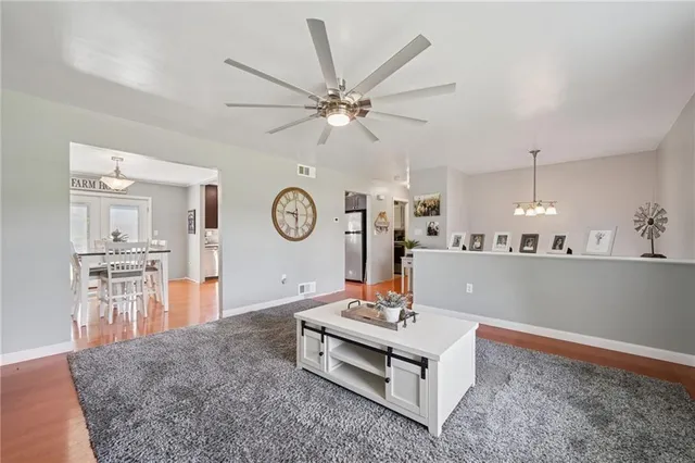 a living room with furniture and a clock