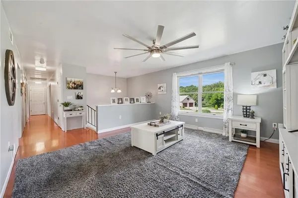 a living room with furniture and a wooden floor