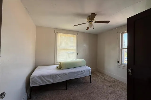 a bedroom with a bed and window