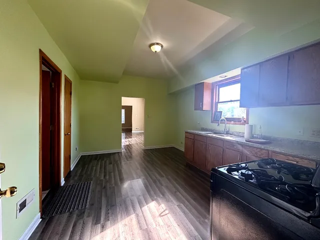 a kitchen with wooden floors and a stove