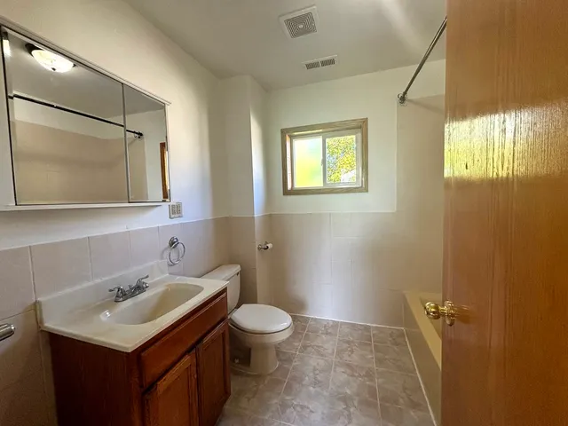 a bathroom with a sink toilet and mirror