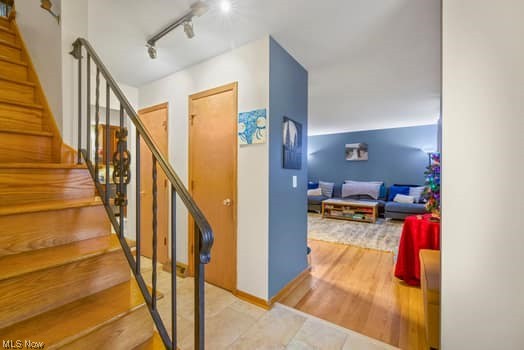 4618 South Arlington Road Uniontown, OH 44685 - Photo 5 of 31 Stairs featuring light wood-type flooring and rail lighting