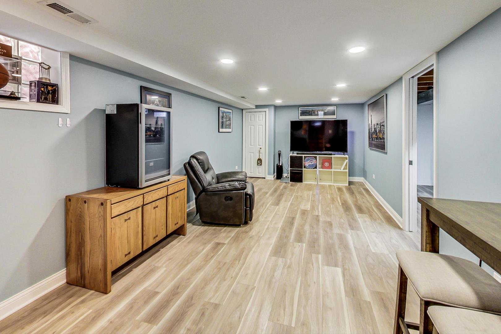3702 South Normal Avenue Chicago, IL 60609 - Photo 25 of 36 a living room with furniture and a flat screen tv