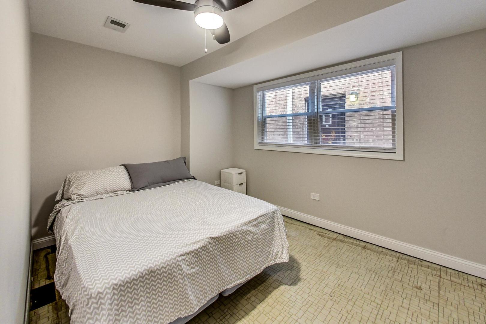 3702 South Normal Avenue Chicago, IL 60609 - Photo 28 of 36 a large bed sitting in a bedroom next to a window