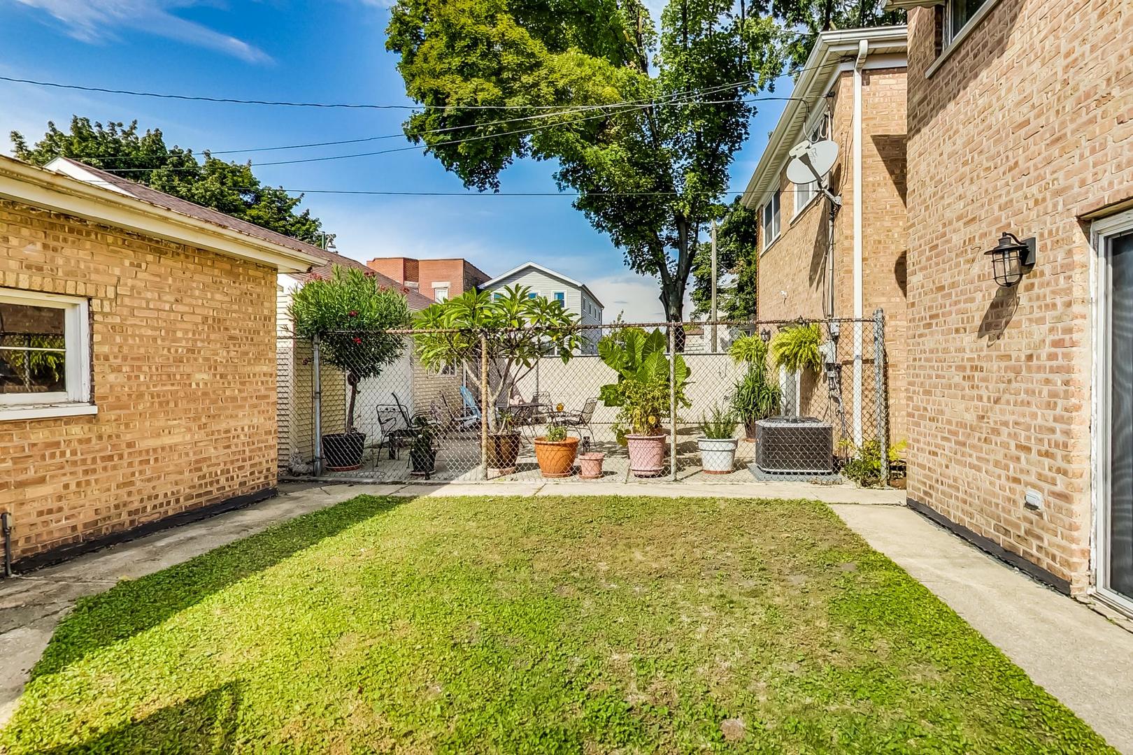 3702 South Normal Avenue Chicago, IL 60609 - Photo 33 of 36 a view of a backyard with plants and patio