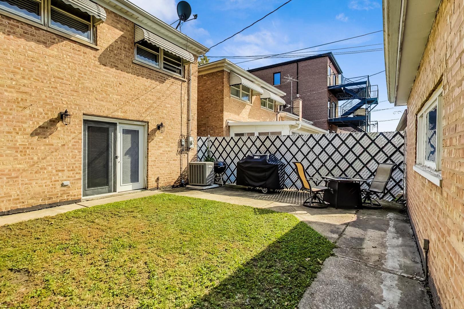 3702 South Normal Avenue Chicago, IL 60609 - Photo 34 of 36 a view of a house with a yard