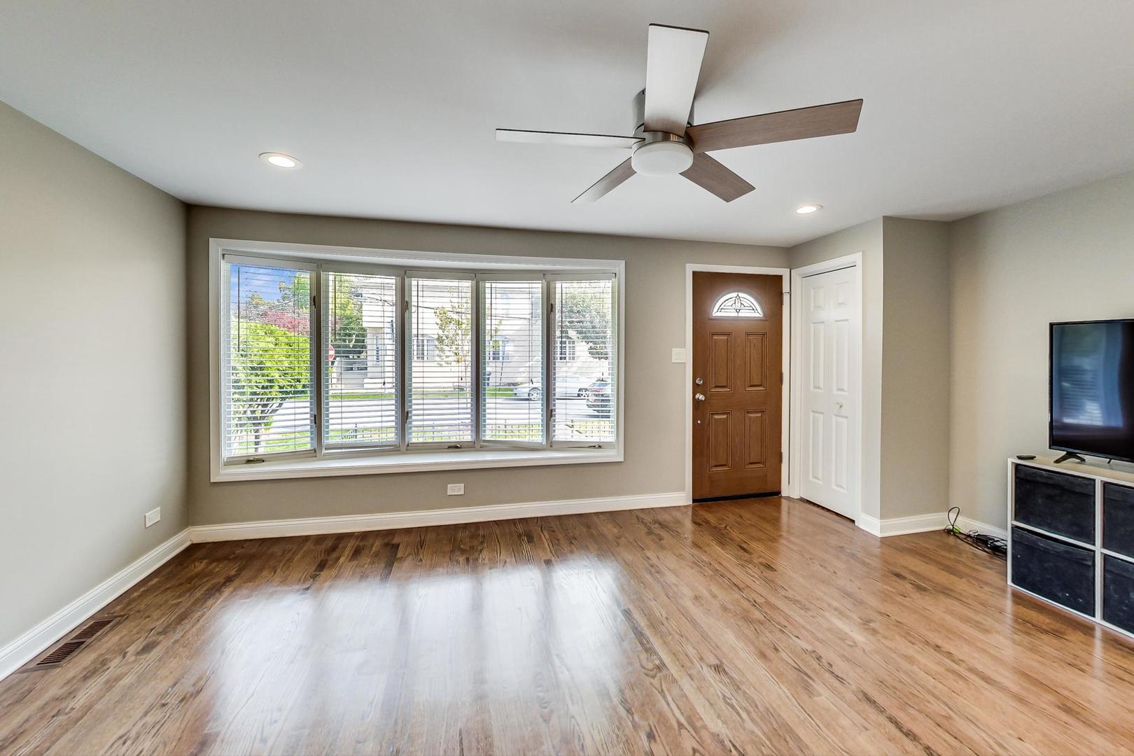 3702 South Normal Avenue Chicago, IL 60609 - Photo 4 of 36 a view of an empty room with wooden floor and a window