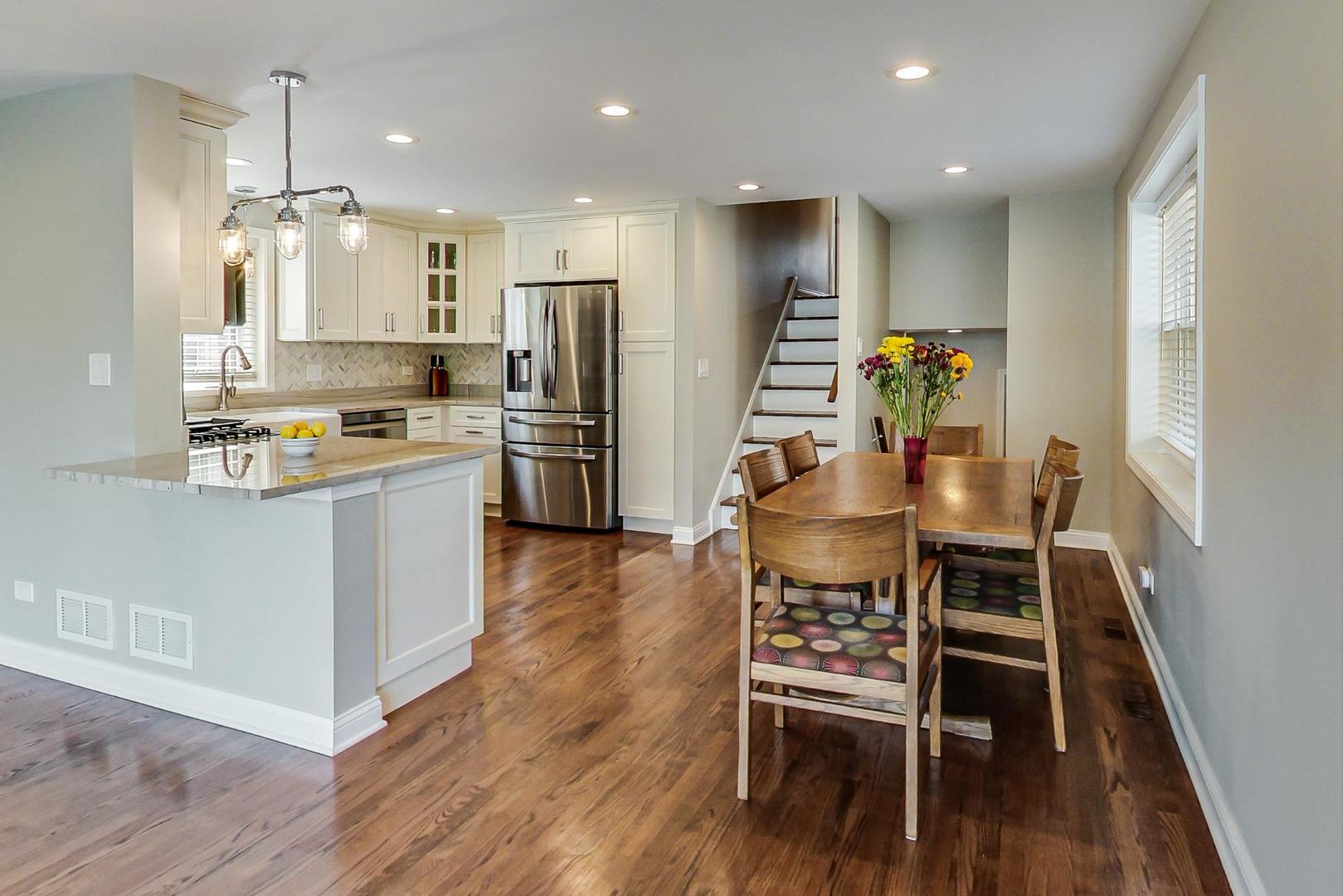 3702 South Normal Avenue Chicago, IL 60609 - Photo 5 of 36 a kitchen with stainless steel appliances kitchen island granite countertop a table chairs refrigerator and microwave