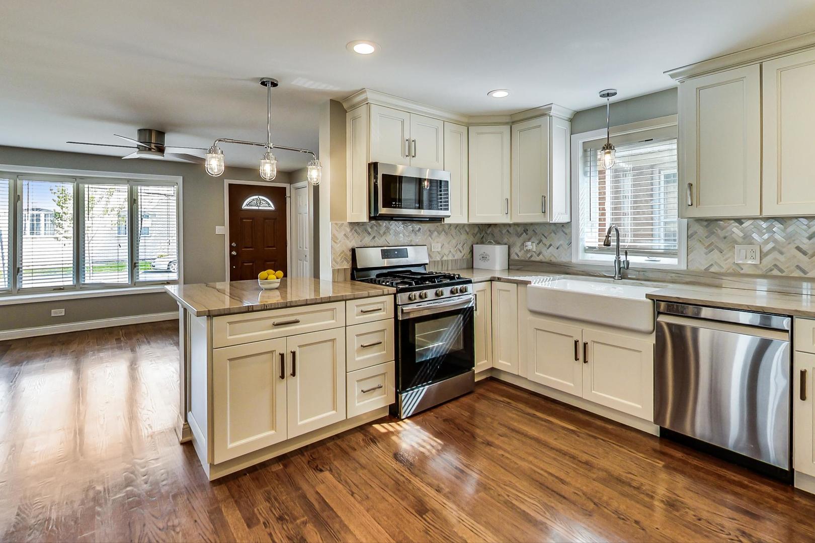 3702 South Normal Avenue Chicago, IL 60609 - Photo 9 of 36 a kitchen with granite countertop a sink cabinets stainless steel appliances and a window