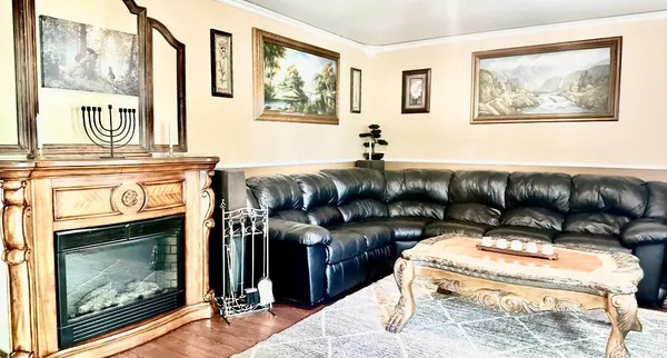 a kitchen with stainless steel appliances granite countertop a refrigerator a stove a sink dishwasher and microwave