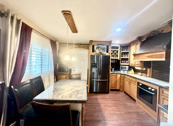 a kitchen with stainless steel appliances granite countertop a refrigerator stove and sink