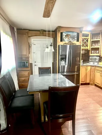 a kitchen with stainless steel appliances granite countertop a refrigerator and a stove top oven