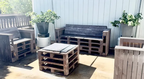 a view of backyard with outdoor seating and trees