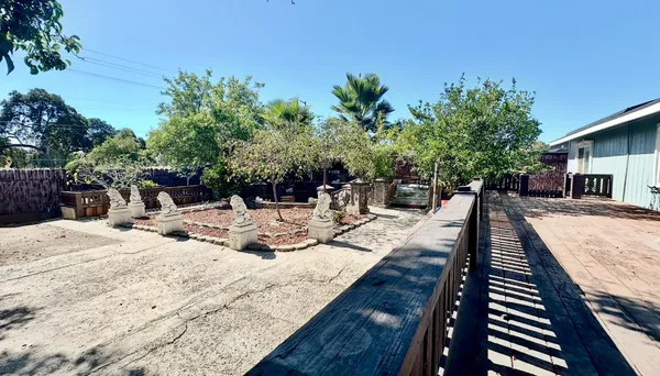 a backyard of a house with table and chairs