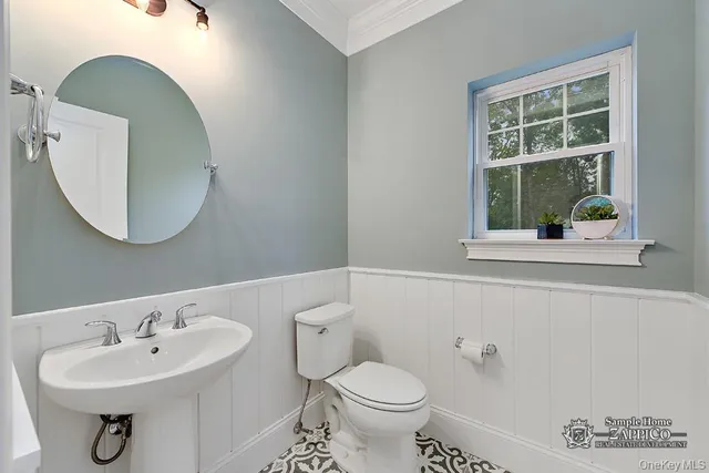 a bathroom with a sink a mirror and a toilet