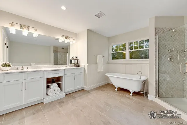 a bathroom with a sink vanity and mirror