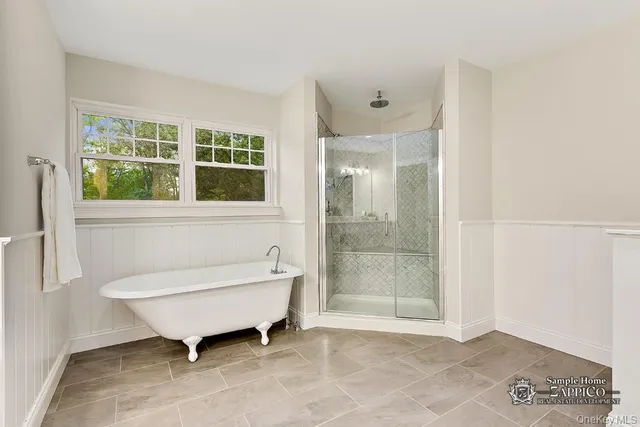 a bathroom with a bathtub and a shower