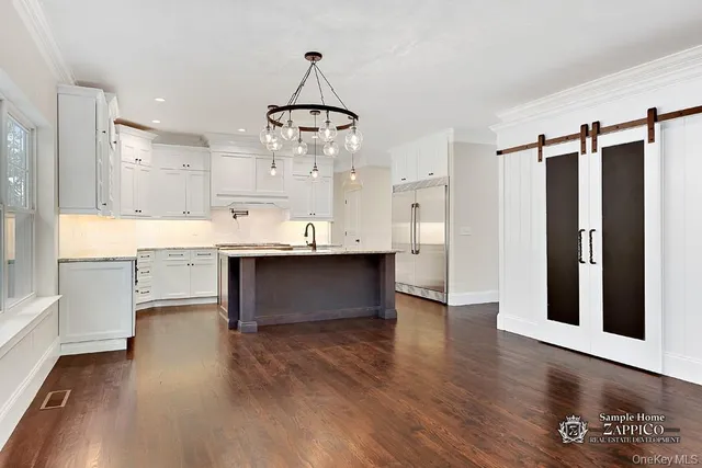 a view of kitchen with stainless steel appliances granite countertop cabinets and wooden floor