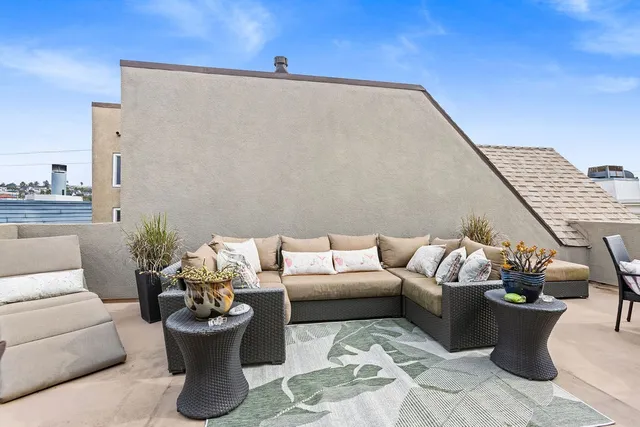 a living room with furniture and a potted plant