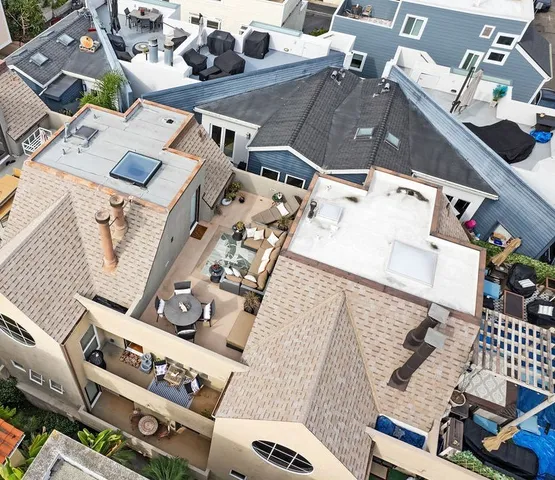 an aerial view of a house with chairs