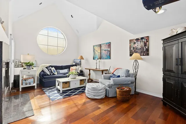 a living room with furniture a flat screen tv and a large window