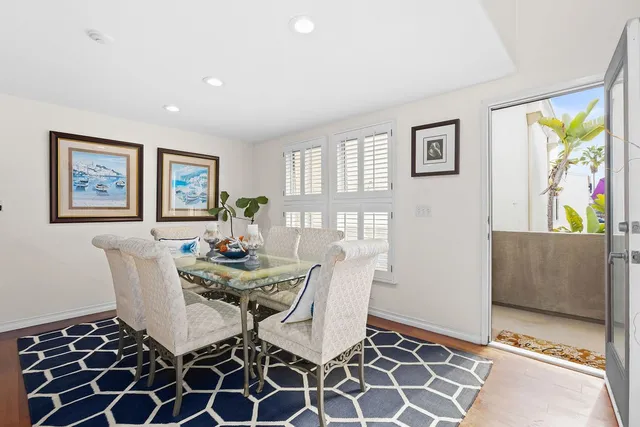 a view of a dining room with furniture and a potted plant